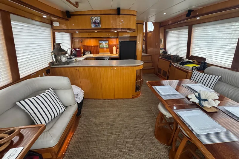 Slide: The Image of Luxurious interior of a 2002 Hampton 550 yacht with elegant wood finishes and cozy seating. - 52