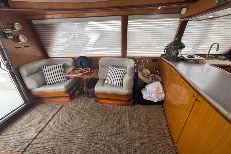 Slide: The Image of Luxurious 2002 Hampton 550 yacht interior with cozy seating and elegant wood finishes. - 54