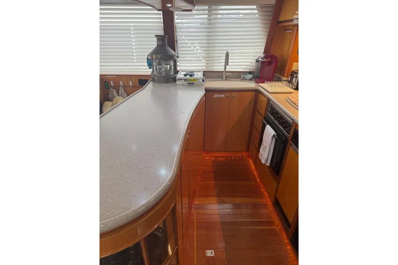 Slide: The Image of Luxurious kitchen interior of 2002 Hampton 550 yacht with modern amenities and wood finish. - 55