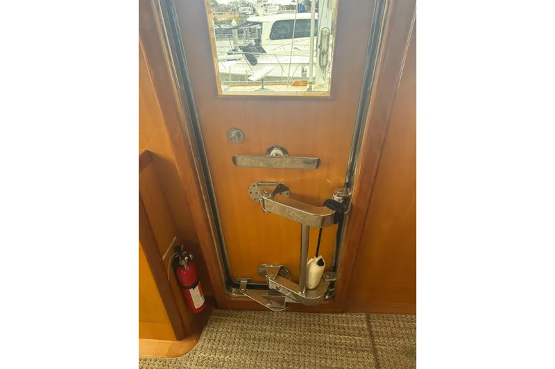 Slide: The Image of Wooden yacht door with metal handle and lock, Hampton 550, 2002 model. - 59