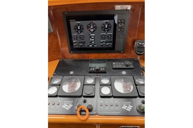 Slide: The Image of Control panel of a 2002 Hampton 550 yacht with digital and analog gauges. - 64