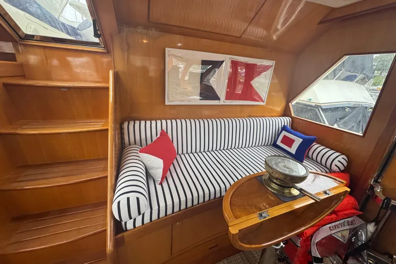 Slide: The Image of Interior of 2002 Hampton 550 yacht with striped seating and nautical decor. - 65