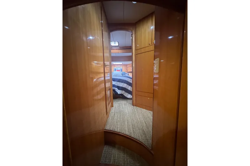 Slide: The Image of Luxurious interior of 2002 Hampton 550 yacht with wood paneling and cozy bedroom. - 71