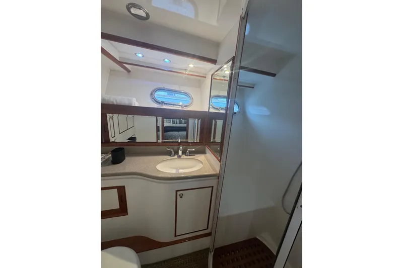 Slide: The Image of Luxurious bathroom in 2002 Hampton 550 yacht with sink, mirror, and shower. - 77