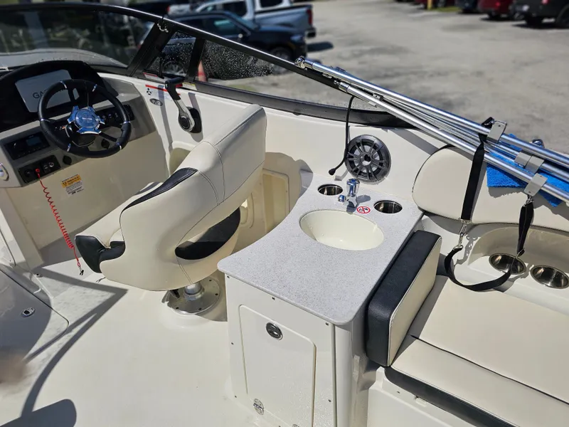 Slide: The Image of Interior of a 2022 Stingray 231 DC boat with steering wheel and sink. - 5