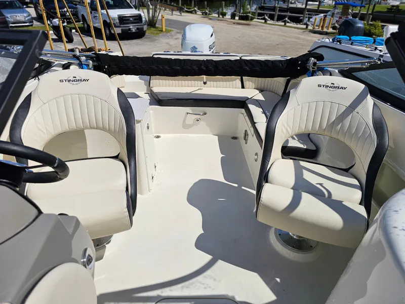Slide: The Image of Interior of a 2022 Stingray 231 DC boat with beige seats. - 6