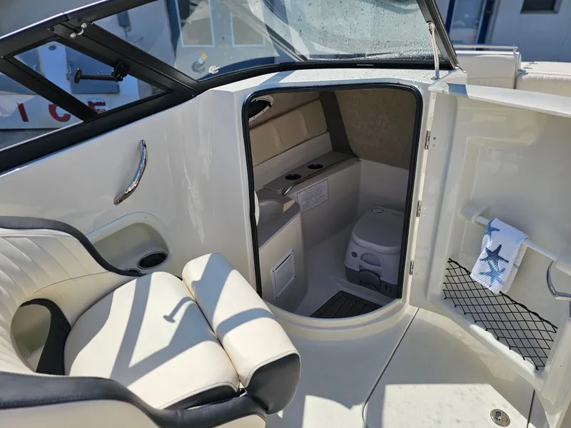Slide: The Image of Interior of 2022 Stingray 231 DC boat with seating and toilet. - 7