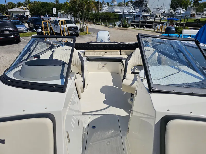 Slide: The Image of Interior view of a 2022 Stingray 231 DC boat at the marina. - 9