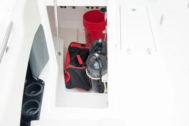 Slide: The Image of 2019 Boston Whaler 230 Vantage boat cockpit with steering wheel and navigation controls. - 16