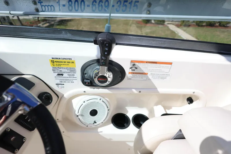 Slide: The Image of 2019 Boston Whaler 230 Vantage dashboard with controls and capacity warning label. - 20