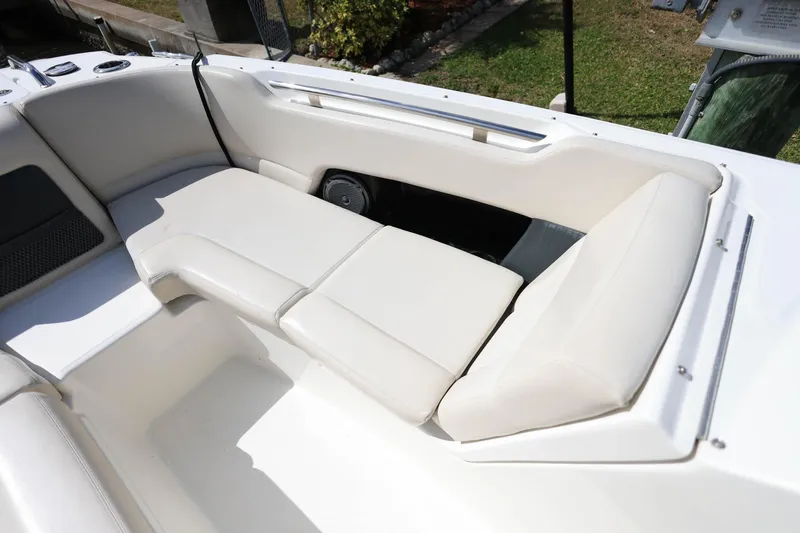Slide: The Image of 2019 Boston Whaler 230 Vantage boat interior with white cushioned seating. - 22