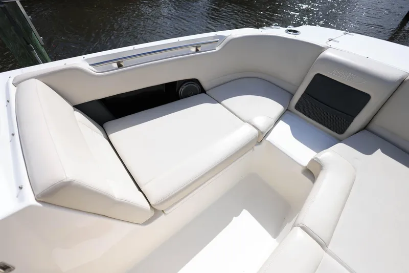 Slide: The Image of 2019 Boston Whaler 230 Vantage boat interior with white cushioned seating. - 23