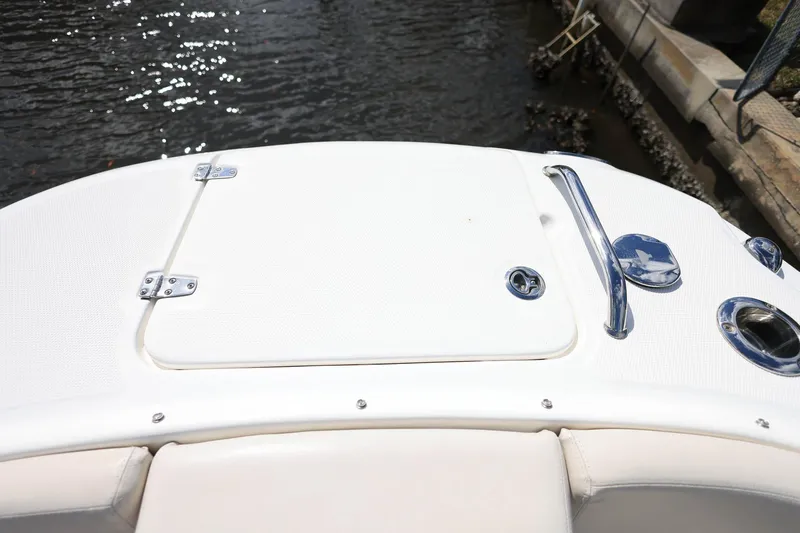 Slide: The Image of 2019 Boston Whaler 230 Vantage boat deck with storage hatch and chrome fittings. - 26