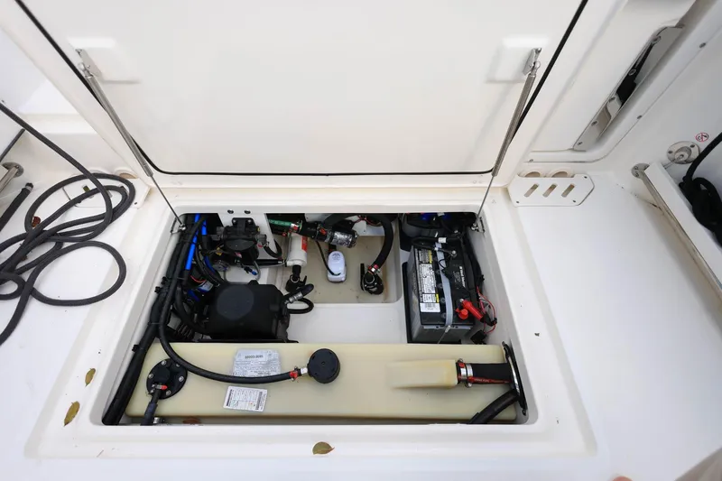 Slide: The Image of 2019 Boston Whaler 230 Vantage boat compartment with battery and wiring. - 30