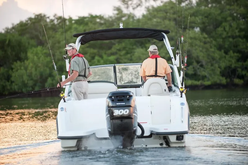 Slide: The Image of 2019 Boston Whaler 230 Vantage boat docked in a canal setting. - 5