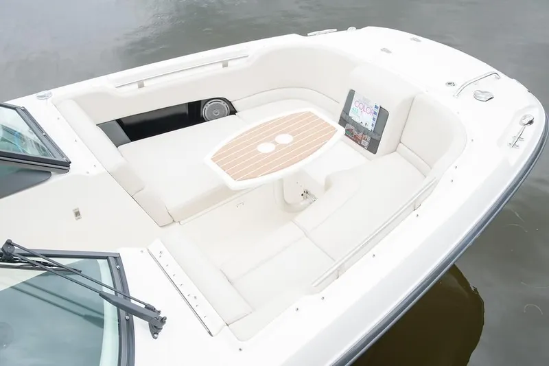 Slide: The Image of 2019 Boston Whaler 230 Vantage boat interior with cushioned seating by the waterway. - 9
