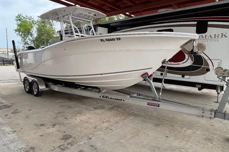 The Image of 2022 Sea Fox 268 Commander boat on trailer, parked outdoors. - 1