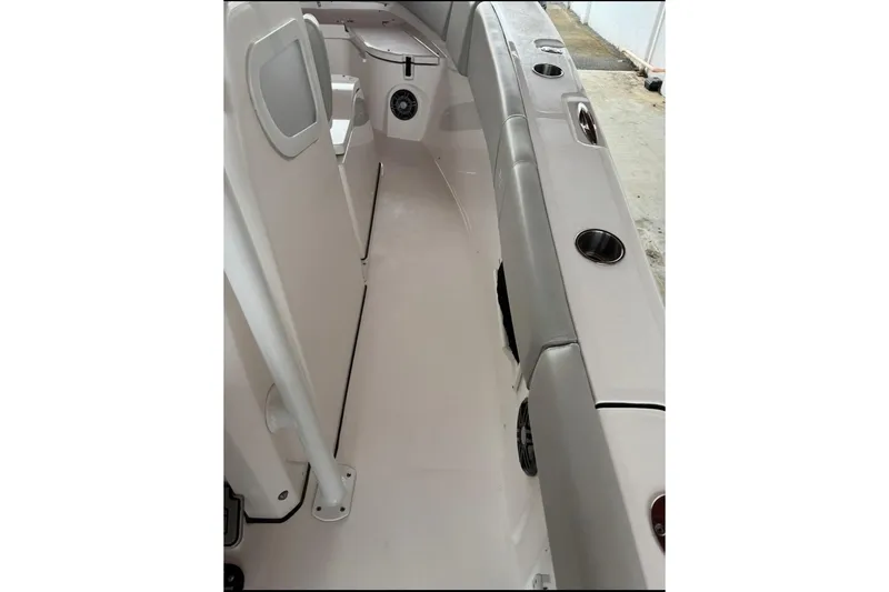 Slide: The Image of Interior view of 2022 Sea Fox 268 Commander boat, featuring seating and cup holders. - 11
