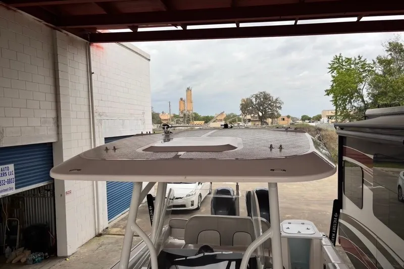 Slide: The Image of 2022 Sea Fox 268 Commander boat under a covered area, showcasing its sleek design. - 17