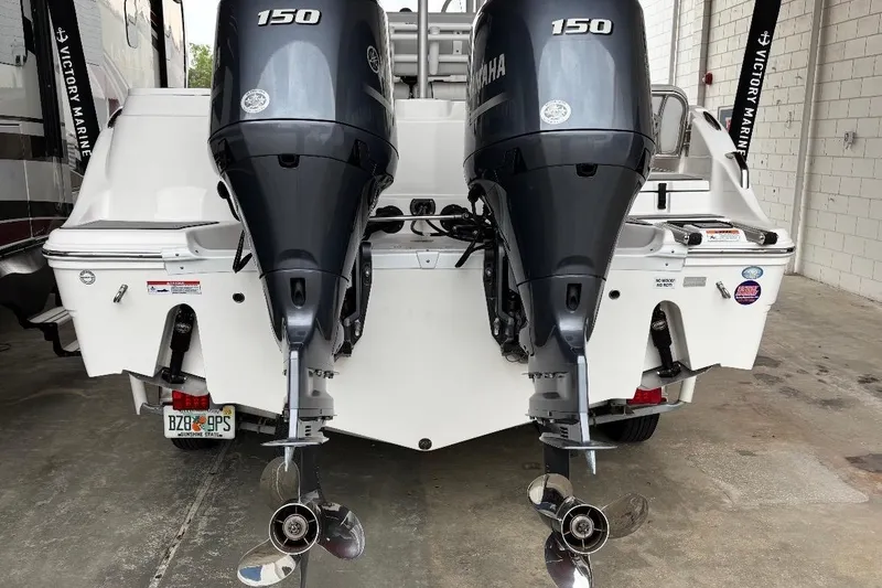 Slide: The Image of 2022 Sea Fox 268 Commander with dual Yamaha 150 engines in a marina setting. - 7