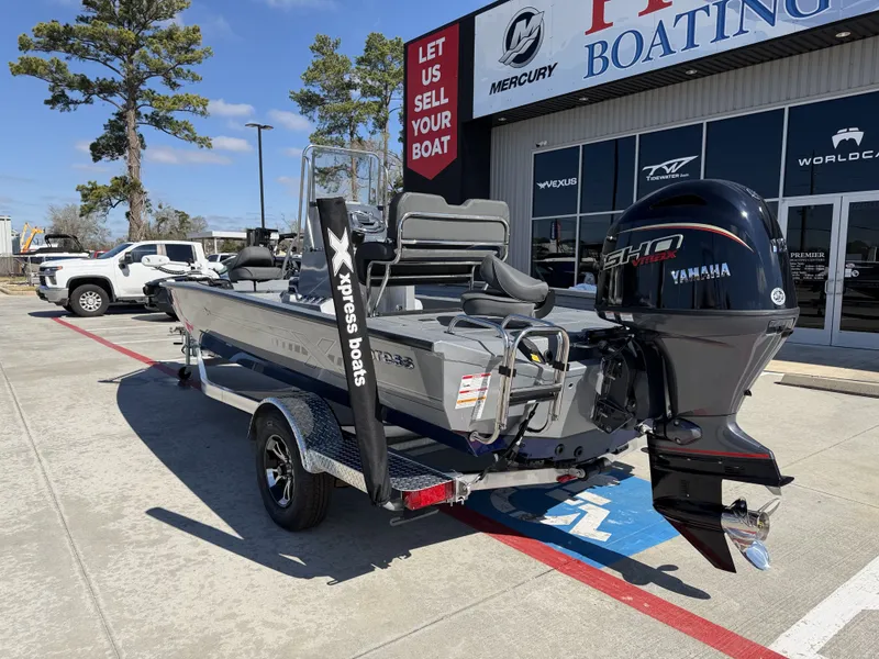 Slide: The Image of 2026 Xpress H20B boat with Yamaha engine outside a boating store. - 10