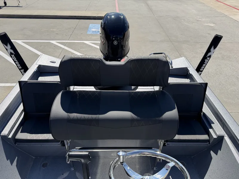 Slide: The Image of 2026 Xpress H20B boat with black seating and motor. - 16