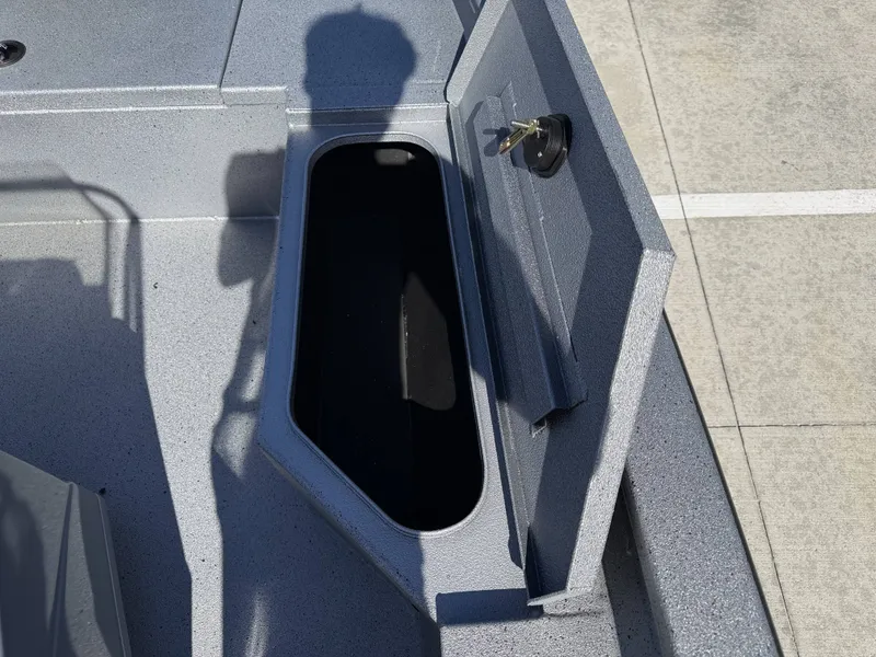 Slide: The Image of Open storage compartment on a 2026 Xpress H20B boat. - 24