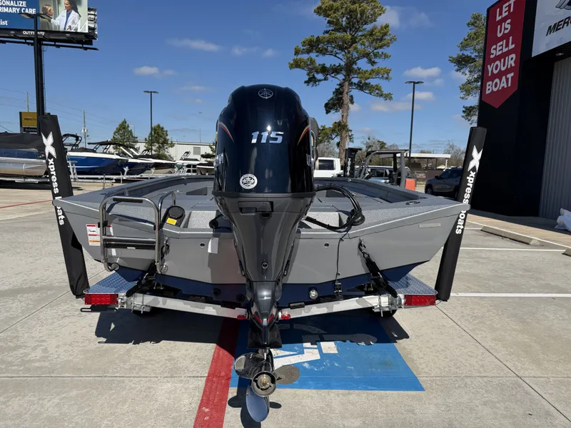 Slide: The Image of 2026 Xpress H20B boat with outboard motor on trailer. - 9
