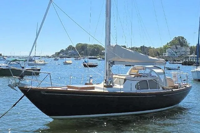 Slide: The Image of 1967 Columbia Constellation sailboat docked in a scenic marina. - 11