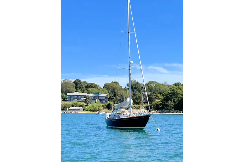 Slide: The Image of 1967 Columbia Constellation sailboat anchored in scenic coastal waters. - 14