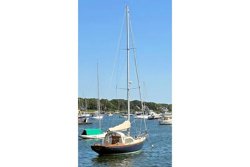 Slide: The Image of 1967 Columbia Constellation sailboat docked in a serene marina setting. - 16