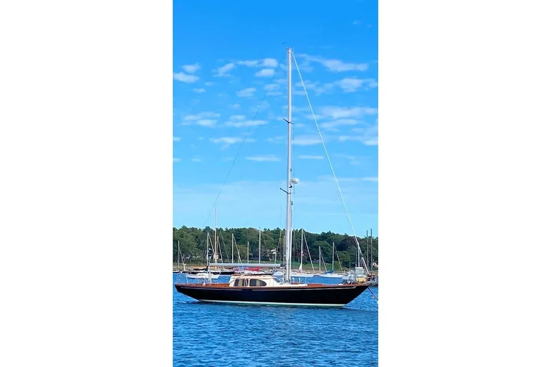 Slide: The Image of 1967 Columbia Constellation sailboat on calm blue water under a clear sky. - 17