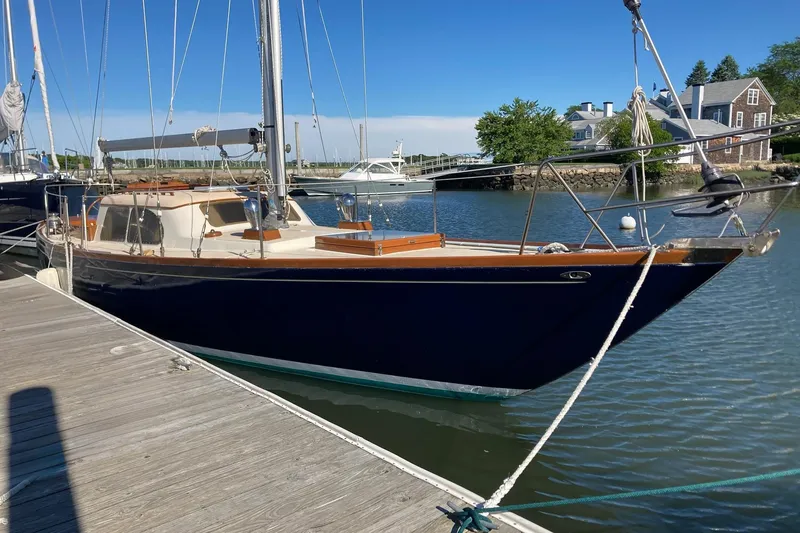 Slide: The Image of 1967 Columbia Constellation sailboat docked in a serene marina setting. - 21