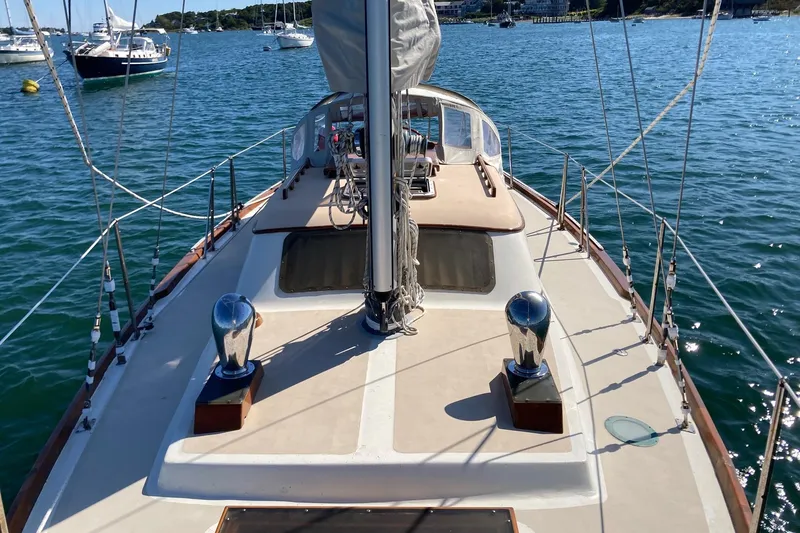 Slide: The Image of 1967 Columbia Constellation sailboat on calm water, showcasing deck and rigging. - 22