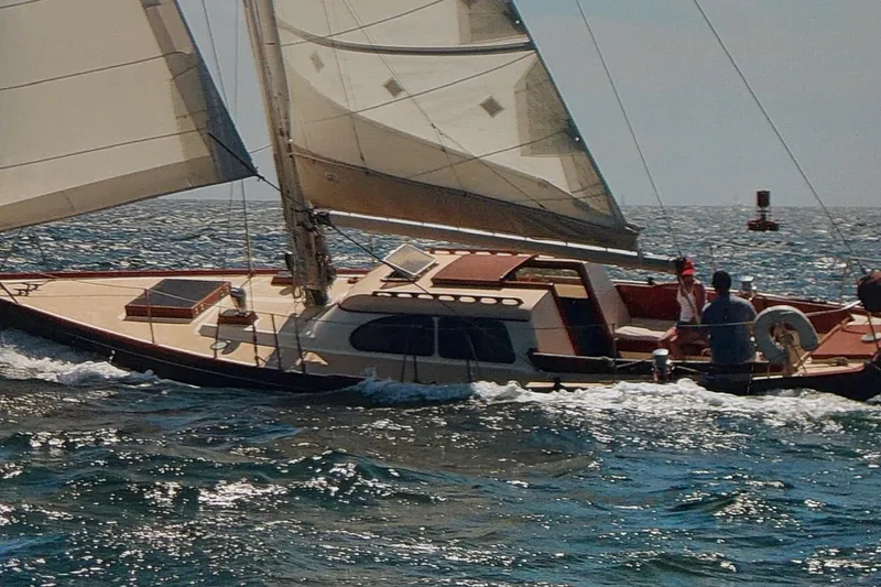 Slide: The Image of 1967 Columbia Constellation sailboat navigating ocean waves under full sail. - 24