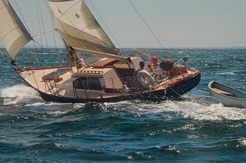 Slide: The Image of 1967 Columbia Constellation sailboat navigating ocean waves with crew onboard. - 25