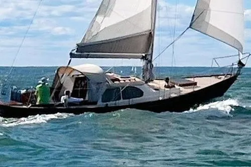 Slide: The Image of 1967 Columbia Constellation sailboat navigating ocean waves under clear skies. - 30