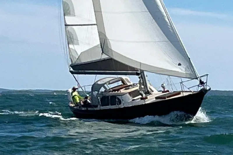 Slide: The Image of 1967 Columbia Constellation sailboat navigating ocean waves under clear skies. - 31