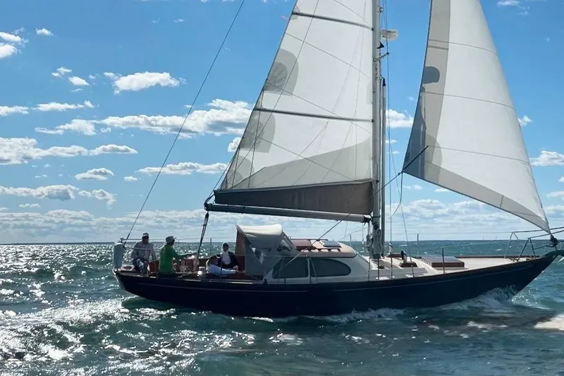 Slide: The Image of 1967 Columbia Constellation sailboat gliding on sunny ocean waters. - 33