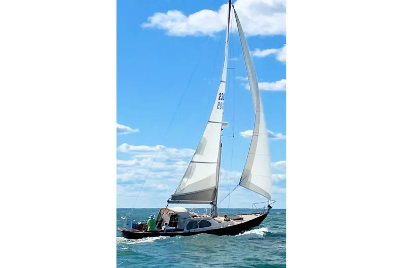 Slide: The Image of 1967 Columbia Constellation sailboat navigating ocean under clear blue sky. - 36