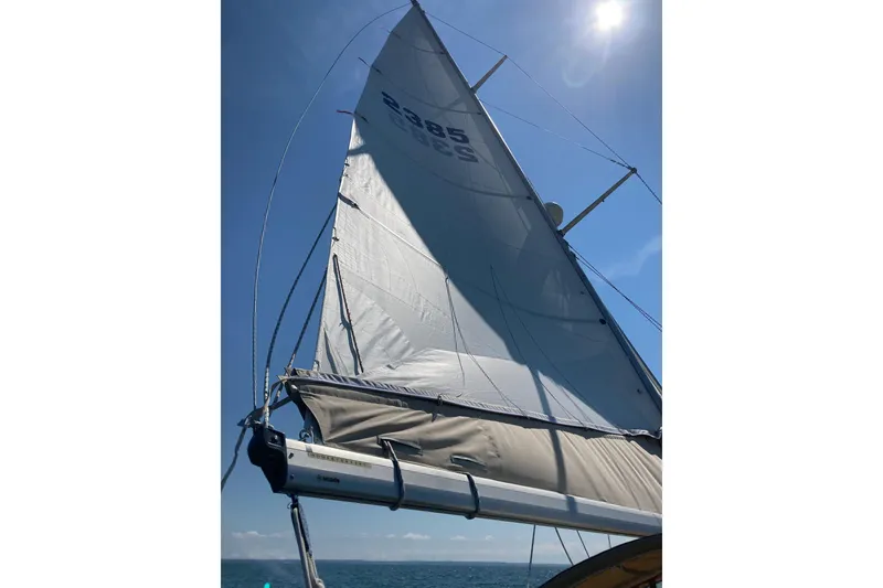 Slide: The Image of Sailing yacht Columbia Constellation 1967 with sails unfurled under clear blue sky. - 38