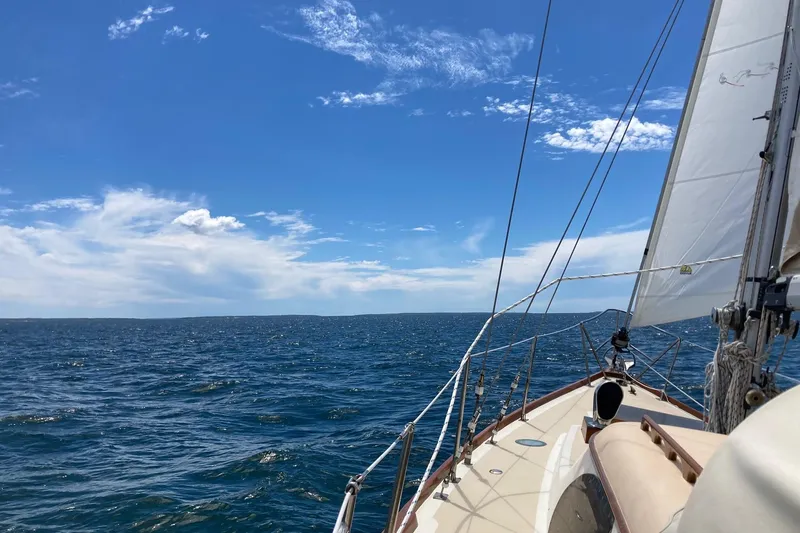Slide: The Image of Sailing on a 1967 Columbia Constellation under clear blue skies and calm ocean waters. - 40