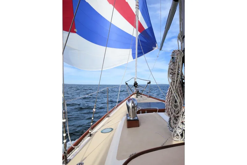 Slide: The Image of 1967 Columbia Constellation sailboat with colorful spinnaker on open sea. - 42