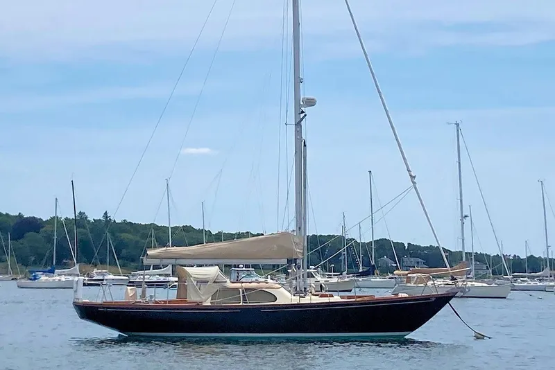Slide: The Image of 1967 Columbia Constellation sailboat anchored in a serene harbor setting. - 5