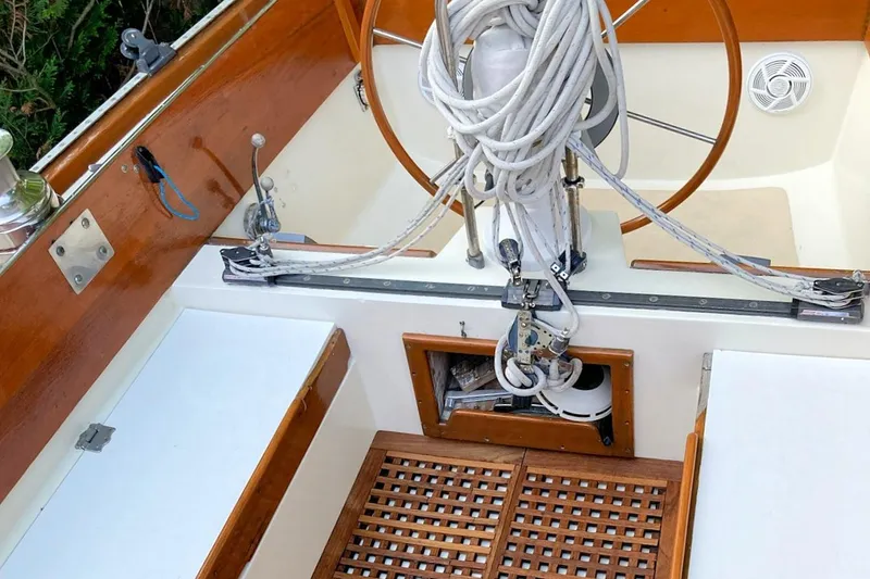 Slide: The Image of 1967 Columbia Constellation sailboat cockpit with wooden accents and coiled ropes. - 62