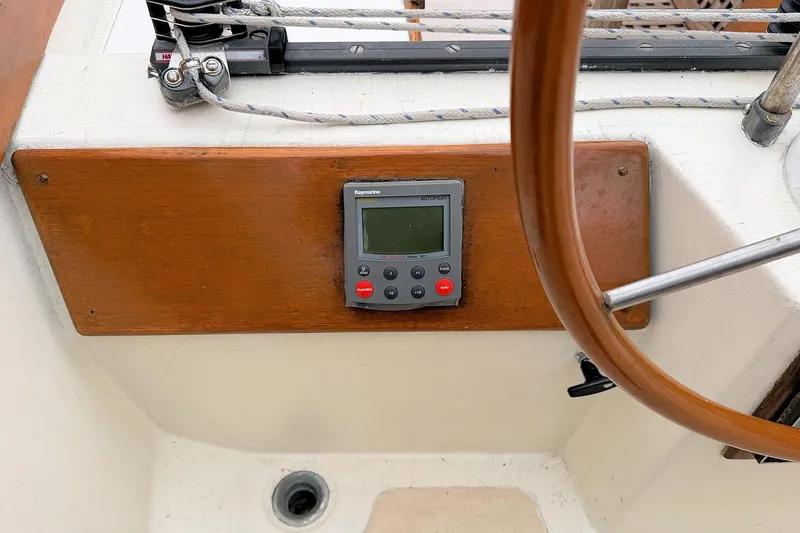 Slide: The Image of 1967 Columbia Constellation yacht cockpit with Raymarine autopilot and wooden steering wheel. - 66