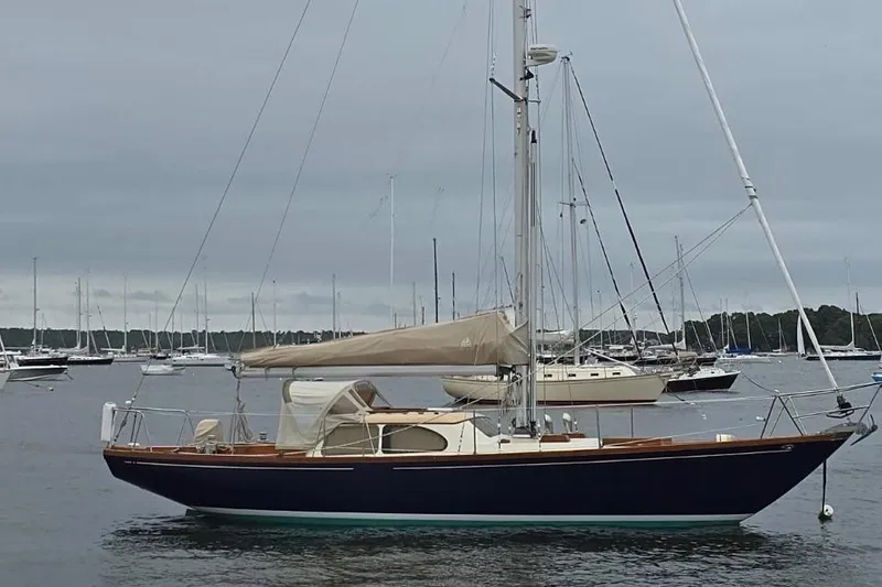 Slide: The Image of 1967 Columbia Constellation sailboat anchored in a marina with overcast skies. - 7