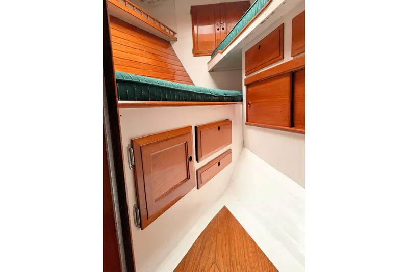 Slide: The Image of 1967 Columbia Constellation boat interior with wooden cabinets and green cushioned seating. - 72