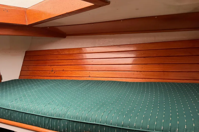 Slide: The Image of 1967 Columbia Constellation boat interior with wooden paneling and green cushioned seating. - 74