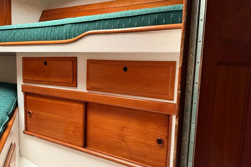 Slide: The Image of 1967 Columbia Constellation interior with wooden drawers and green cushioned seating. - 75
